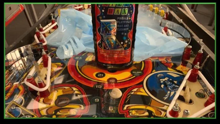 Polishing the playfield protector with a soft cloth