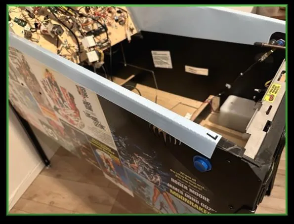 Playfield being raised with the service protector in place